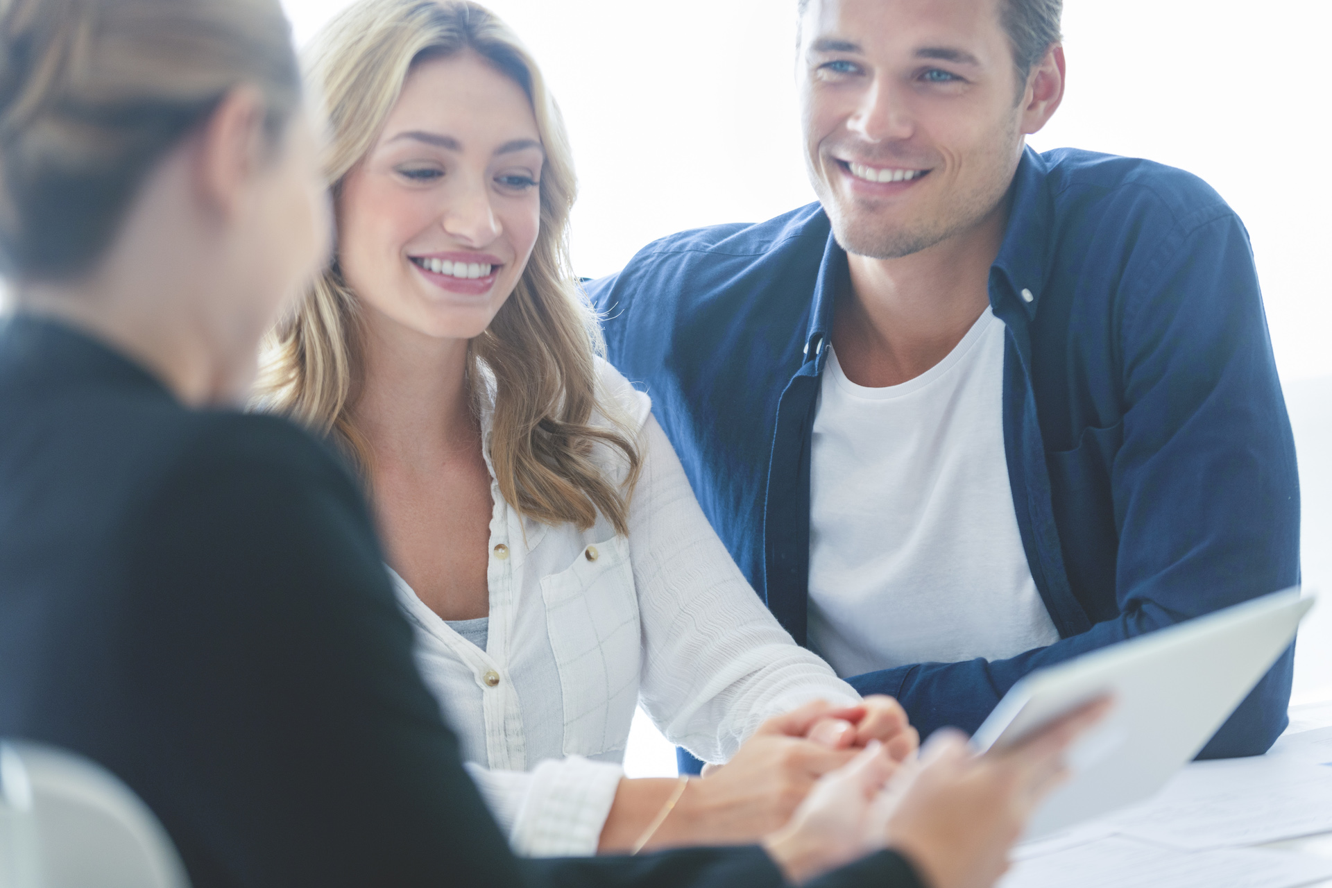 Finance advisor talking to couple about financial goals, best bank account, savings account