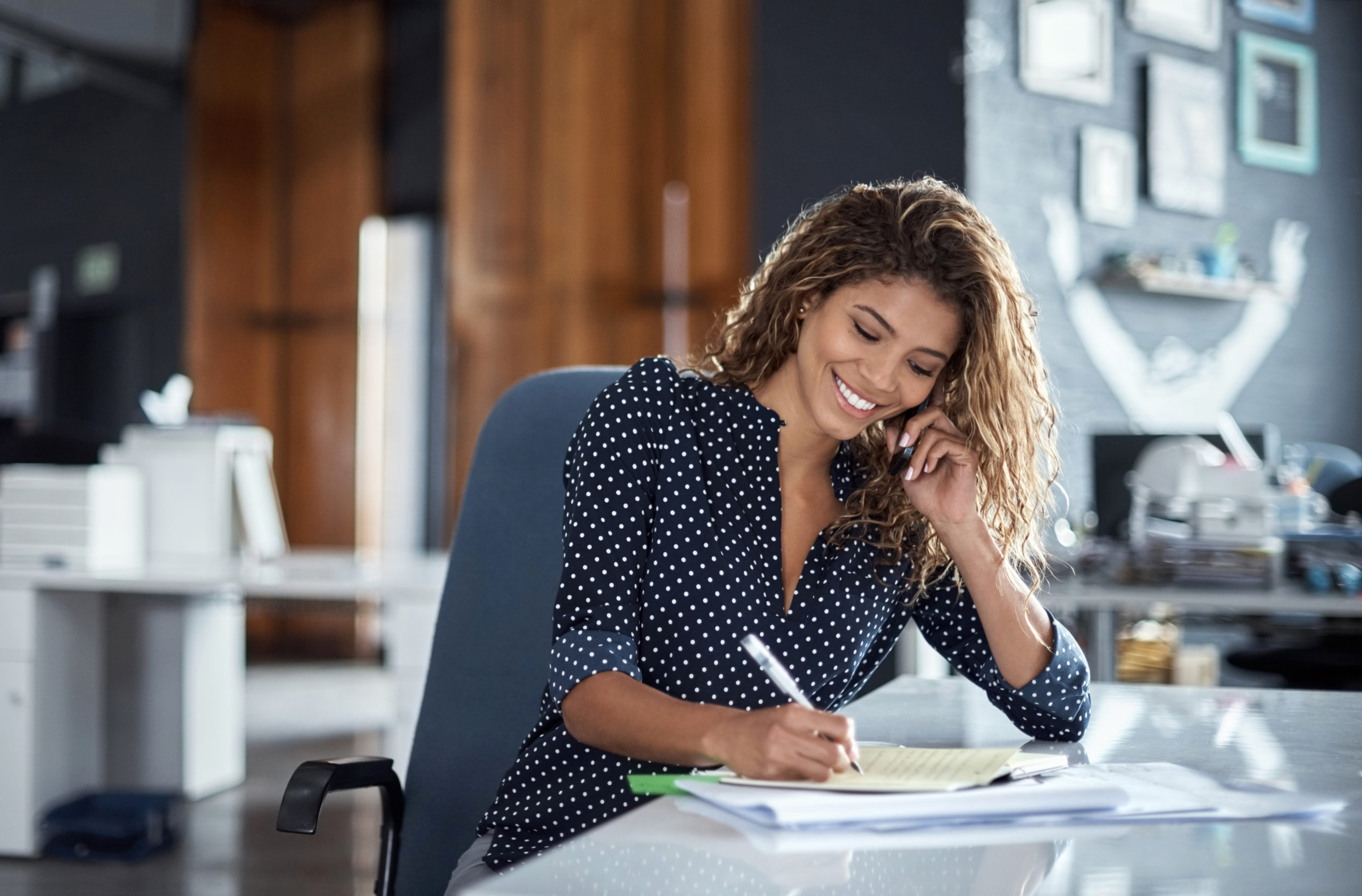 Taking notes of her business call Treasury Management Business Services, Bennington State Bank